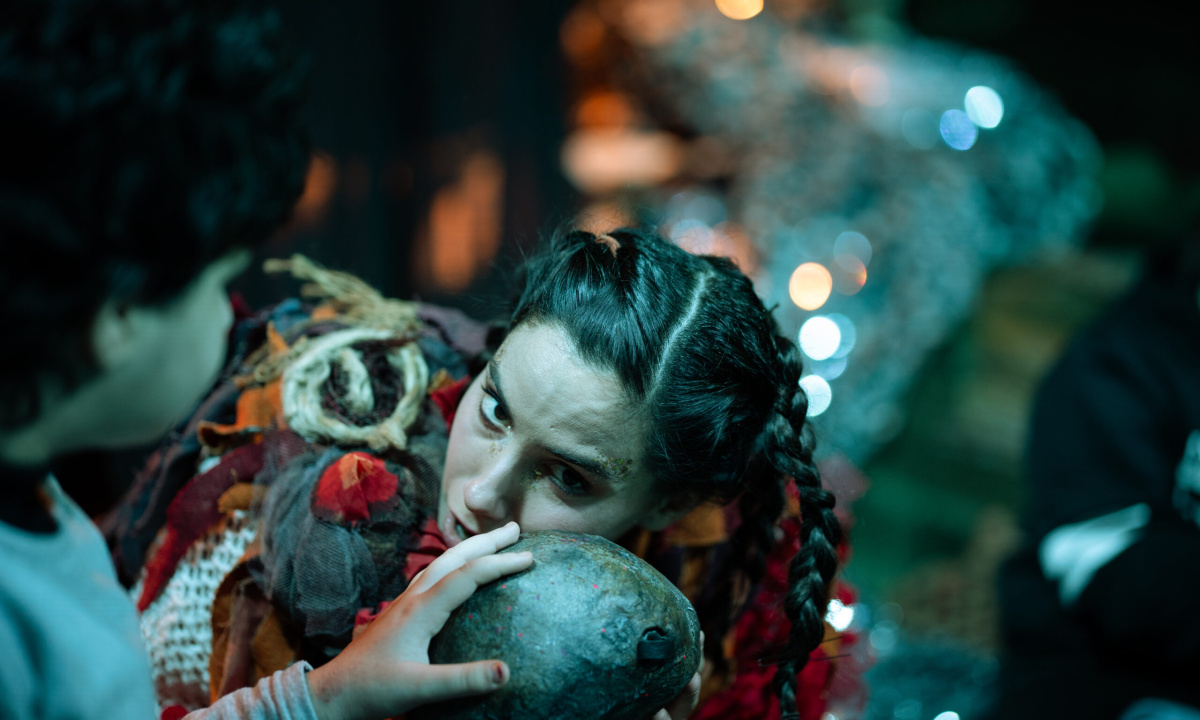 An actor is listening to a stone