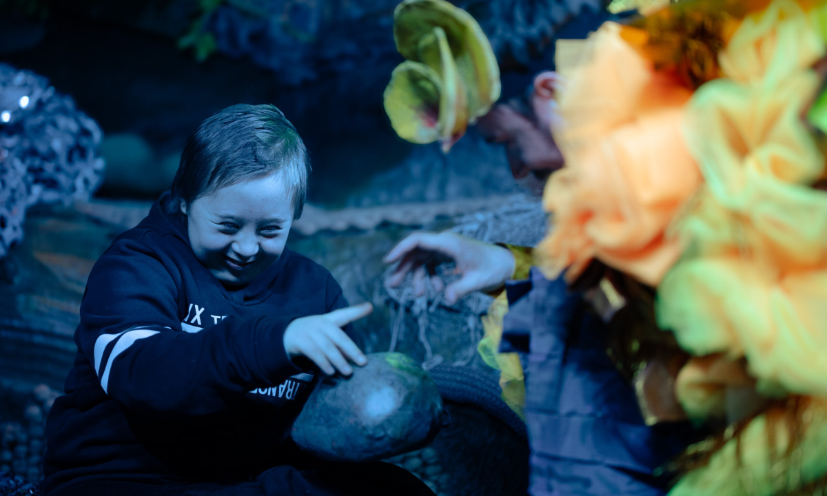 A child is investigating a stone