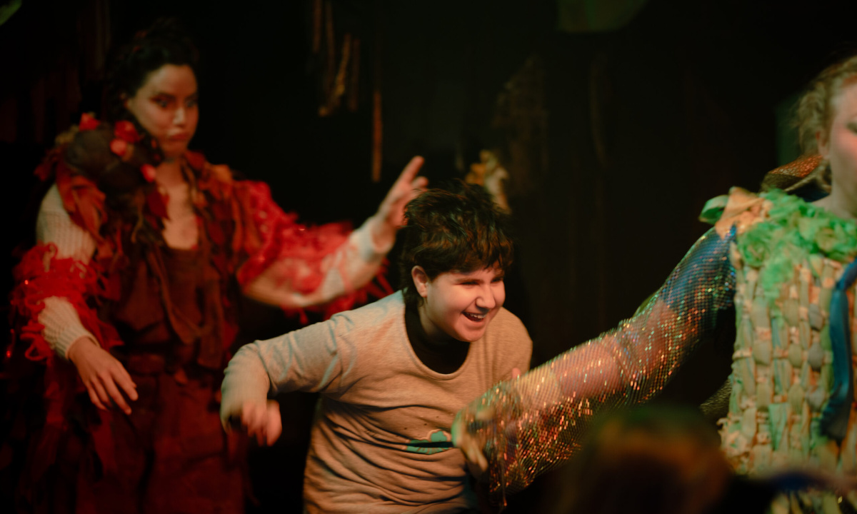 a child playing in the set with the actors