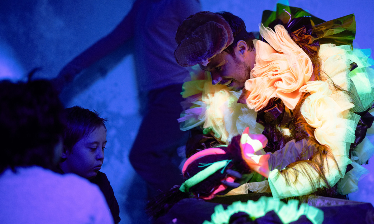 Costume and props are lit up in the dark