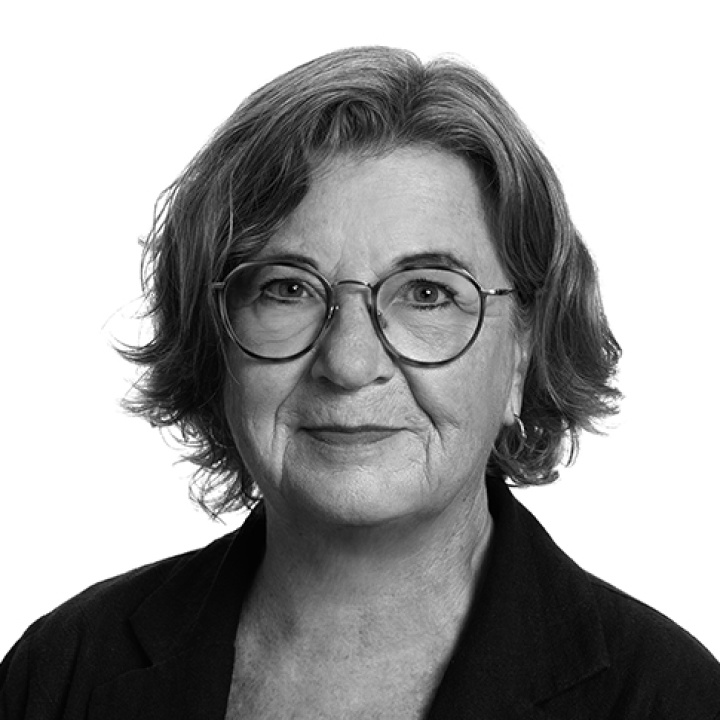 Upper-middle-aged woman with fairly short dark blond hair, fair skin and glasses.